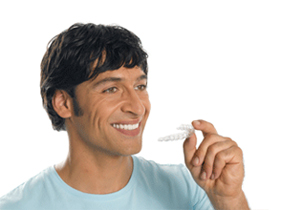 Man inserting Invisalign Clear Braces